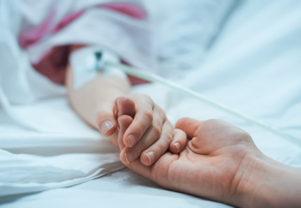 maminka drží ruku dítěte v nemocnici s vrozenou malformací 